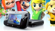 A Nintendo Wii U with Mario Kart 8 playing on the gamepad, images of a Splatoon squid kid, Mario, The Legend of Zelda: Wind Waker's Link, and Animal Crossing's Isabelle in the background.