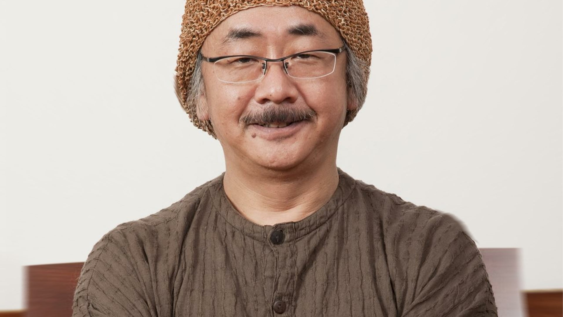 Final Fantasy composer Nobuo Uematsu smiles successful  a beanie chapeau  and glasses