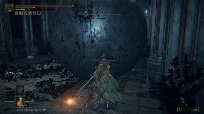 A warrior stands in front of a large ball  in Nokstella in Elden Ring