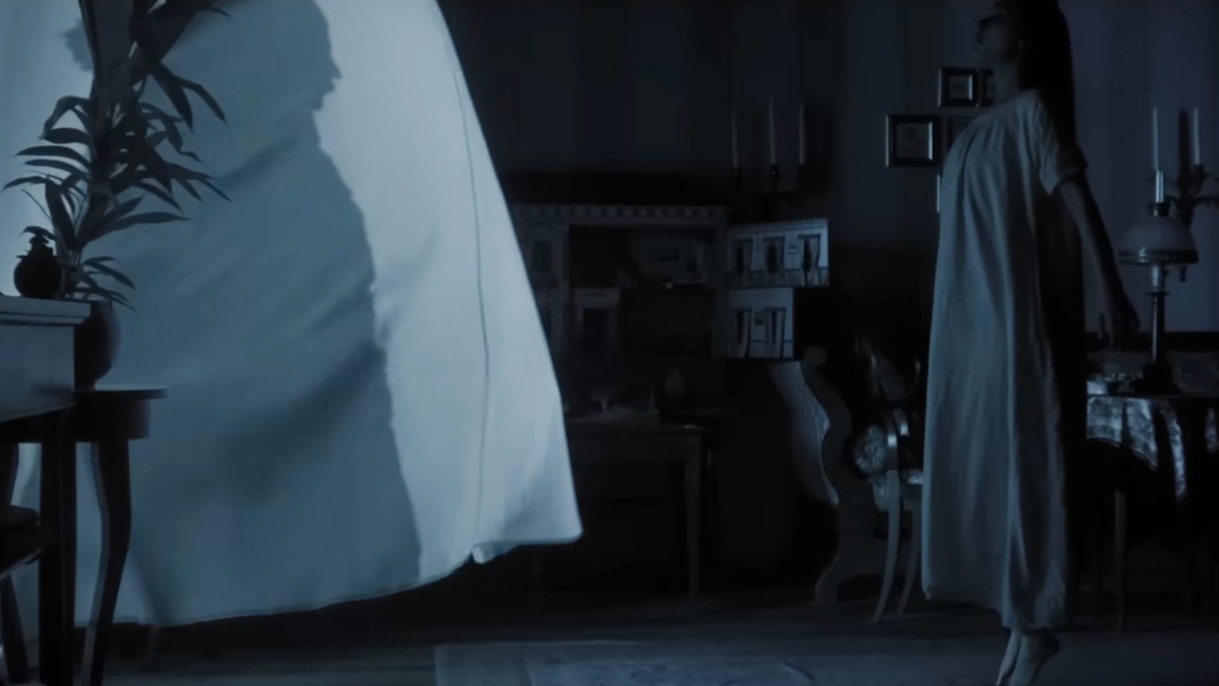 A woman in a nightgown beginning to float, a white curtain with the shadow of Nosferatu billowing in front of her. - 1
