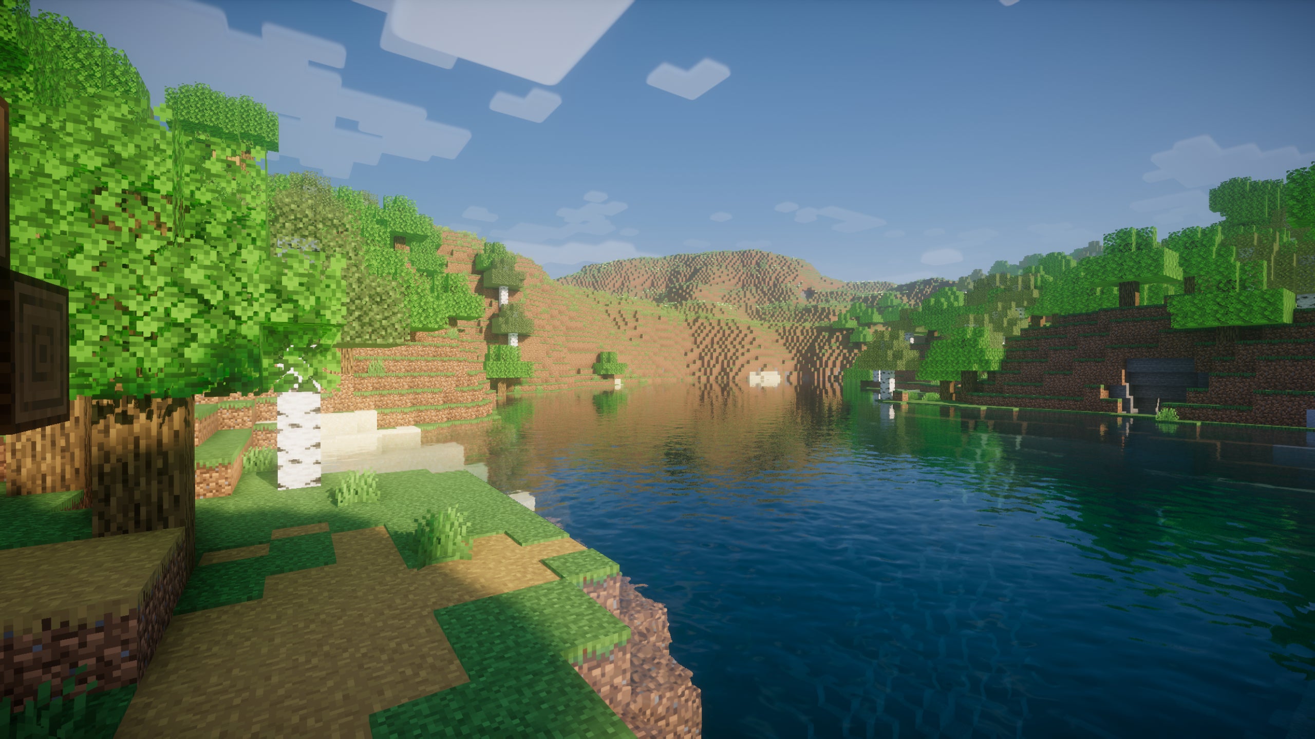 A screenshot of a river in Minecraft, with some trees on either side of the bank and a hill in the distance, taken using Nostalgia shaders.