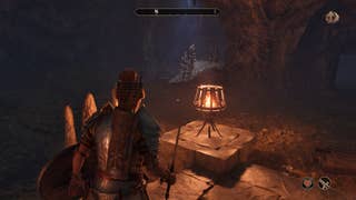 A sword and shield-wielding Nord warrior exploring a Necromancer's cave in Oblivion Remastered.