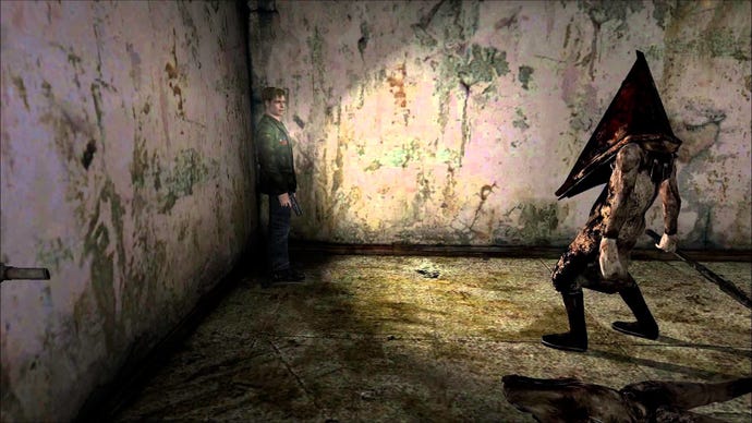 A screen from the original Silent Hill 2 showing Pyramid Head advancing on James in a dingy room