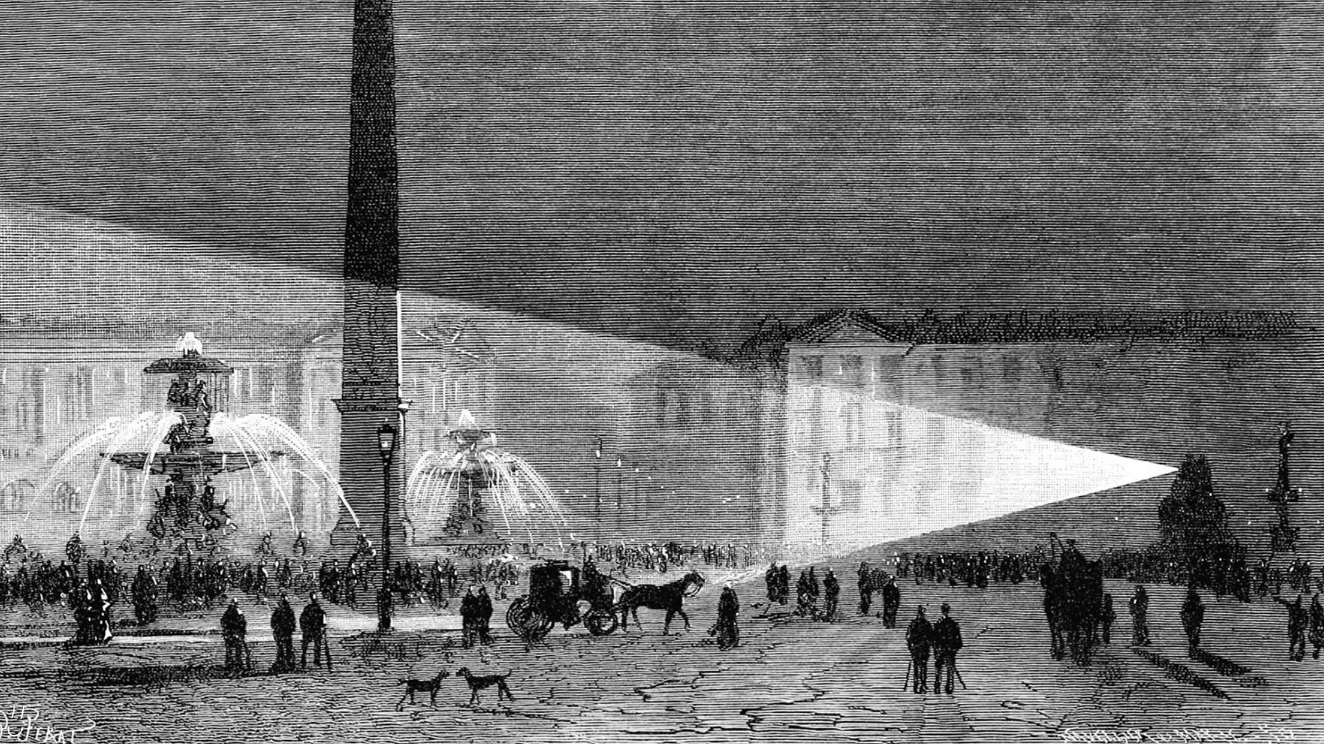 An old black and white vintage illustration of a view of place de la Concorde at night, looking north, showing the Fountain of the Seas, the Luxor Obelisk, and the Fountain of the Rivers caught in a dazzling beam of light coming from the right of the picture. A small crowd gathered in loose groups has come to witness the event as carriages drive by, going on their usual business. - 1