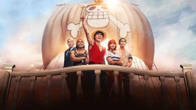 The live-action One Piece crew stood near a wooden railing on a boat, the boat's sails billowing in the wind, a cartoon skull and crossbones on it.