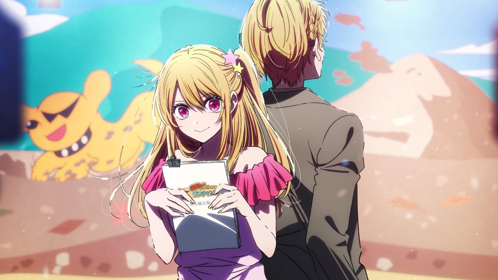 Ruby Hoshino, a young woman with pink eyes and blonde hair in a ponytail, is holding a script while on a TV set, her brother at her back facing the other direction. - 1