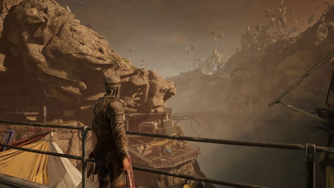 A player character looking out over a rocky valley in Outriders, running at 4K Ultra settings with DLSS Performance enabled