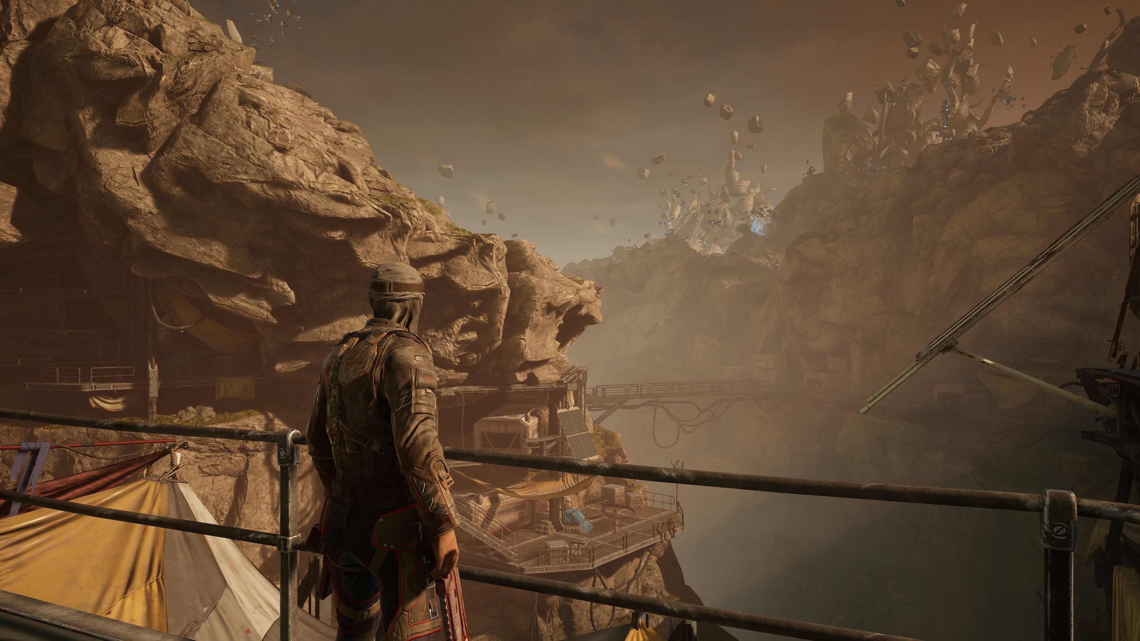 A player character looking out over a rocky valley in Outriders, running at 4K Ultra settings with DLSS Quality enabled