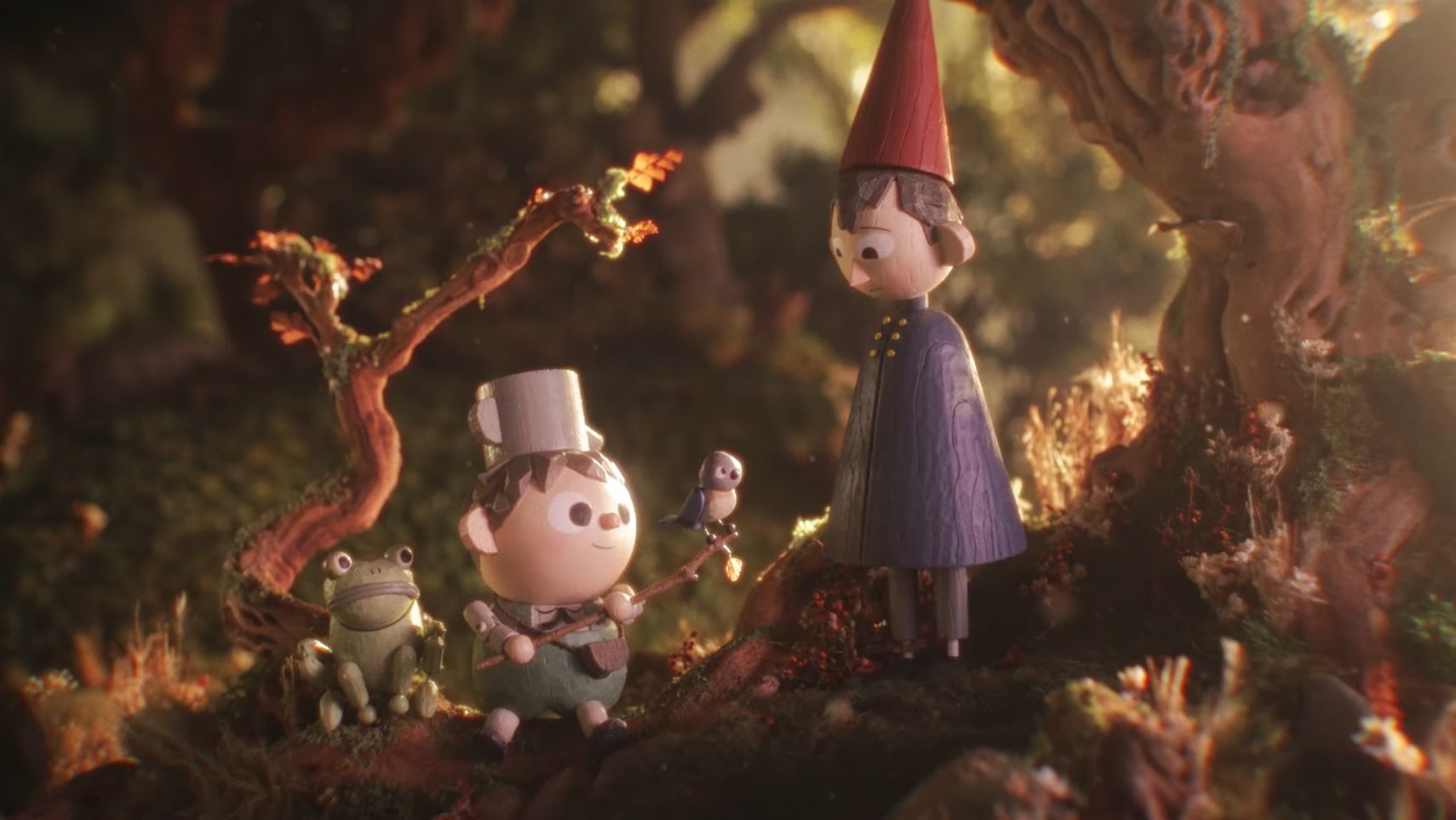 Wirt, Greg, Beatrice, and a frog from Over the Garden well all rendered in a wooden, stop-motion style. - 1