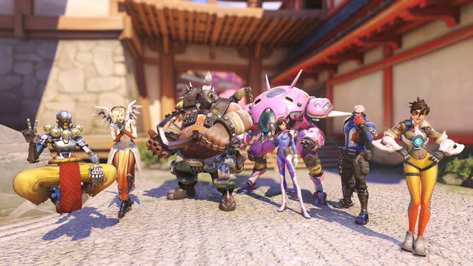 A team in Overwatch gathers to pose for the camera, with Roadhog and Dva in the centre.
