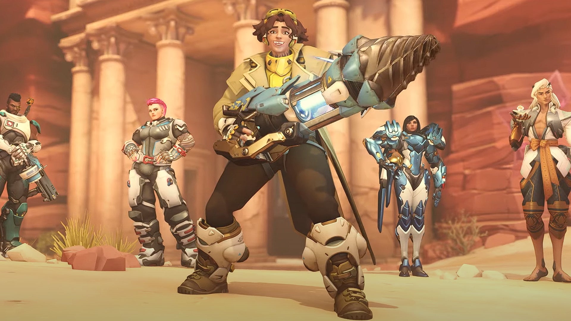 Overwatch 2's new damage hero Venture holds their drill-gun and smiles in front of a row of other characters - 1