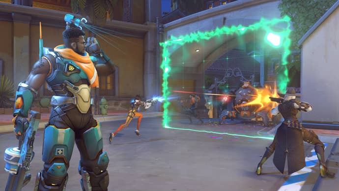 Baptiste, a hero in Overwatch 2, is shown standing on the left while his team fights on the right from behind one of Baptiste’s barriers.