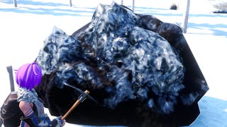 Palworld, a purple haired player holding a pickaxe in the snow is facing a large grey rock.