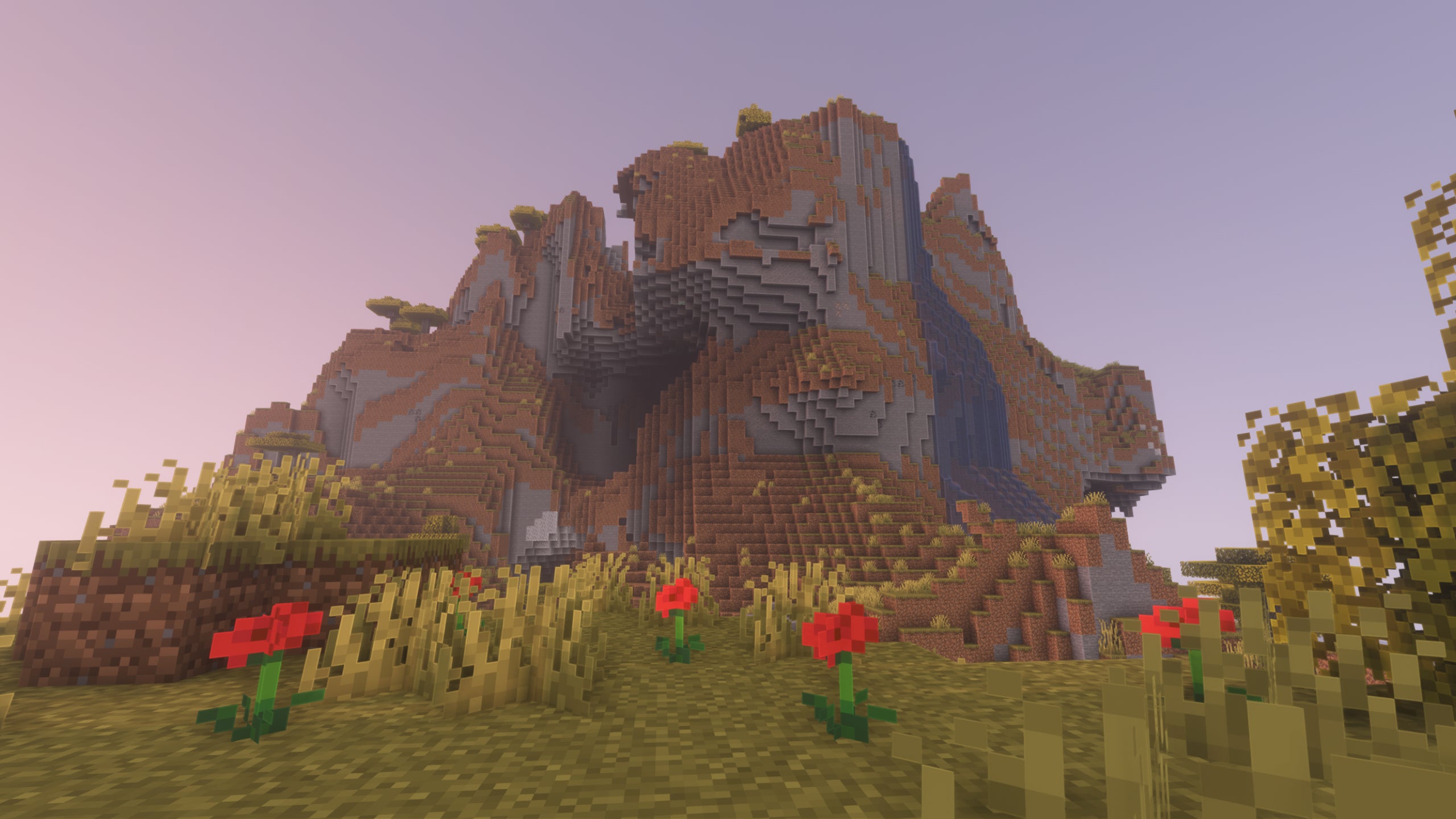 An extreme hills biome in Minecraft, with roses in the foreground showcasing Pastel Shaders.