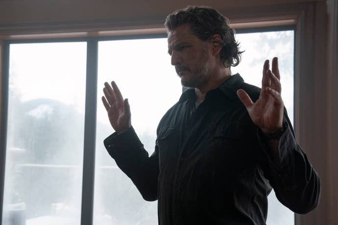 Joel raises his hands in surrender in TLOU season two