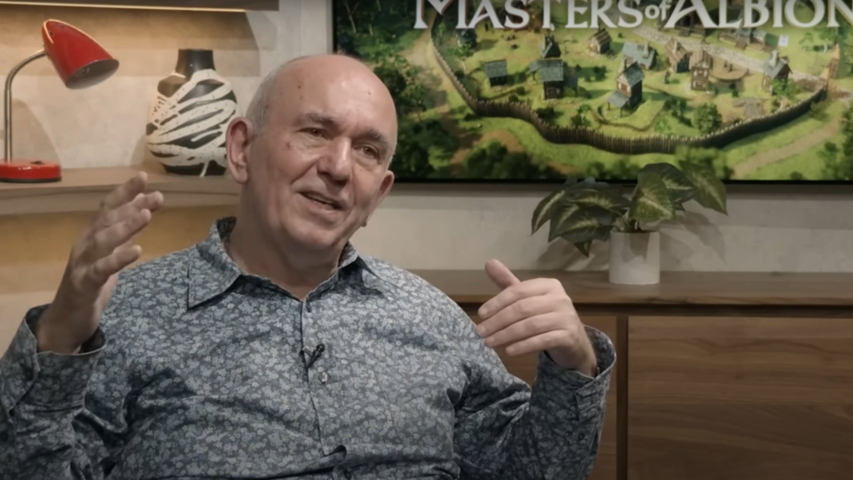 22cans founder Peter Molyneux in front of a screen saying Masters of Albion. - 1