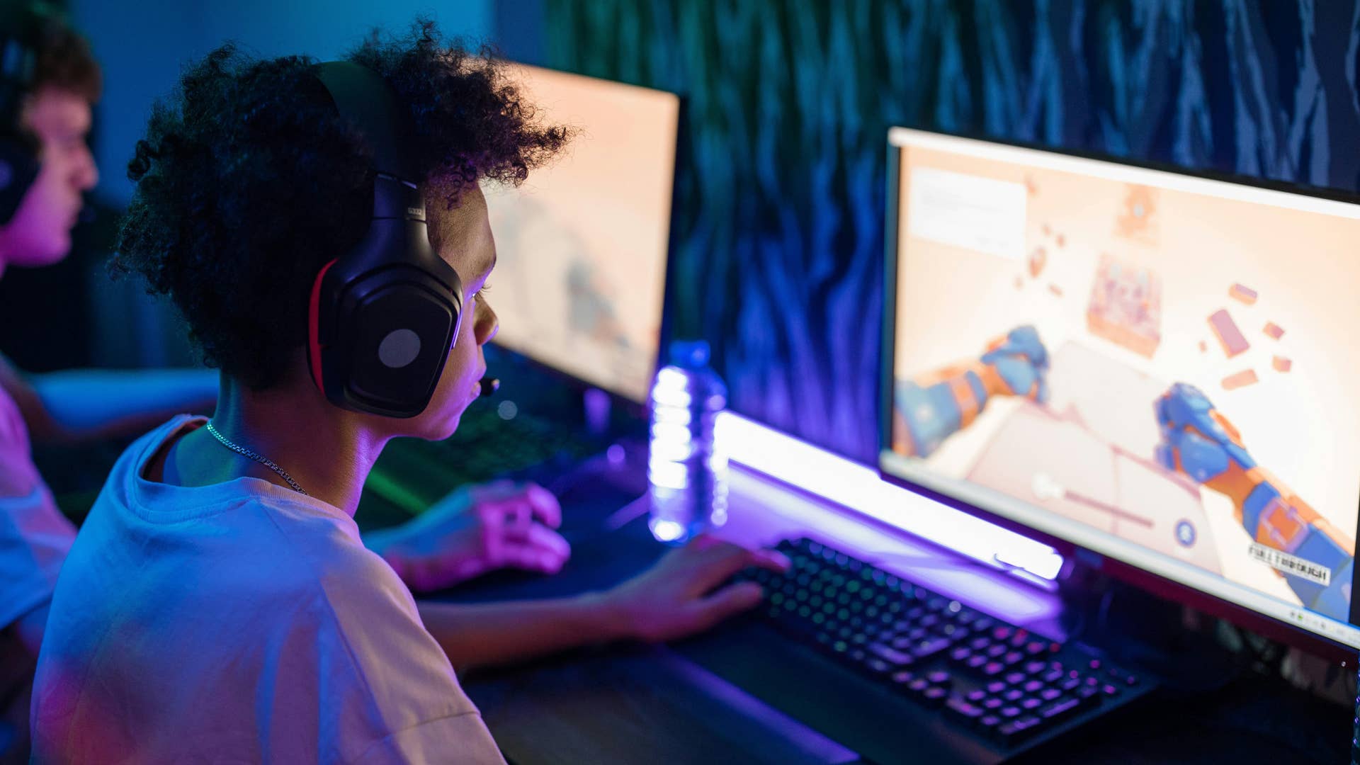 a young man playing video games on a computer