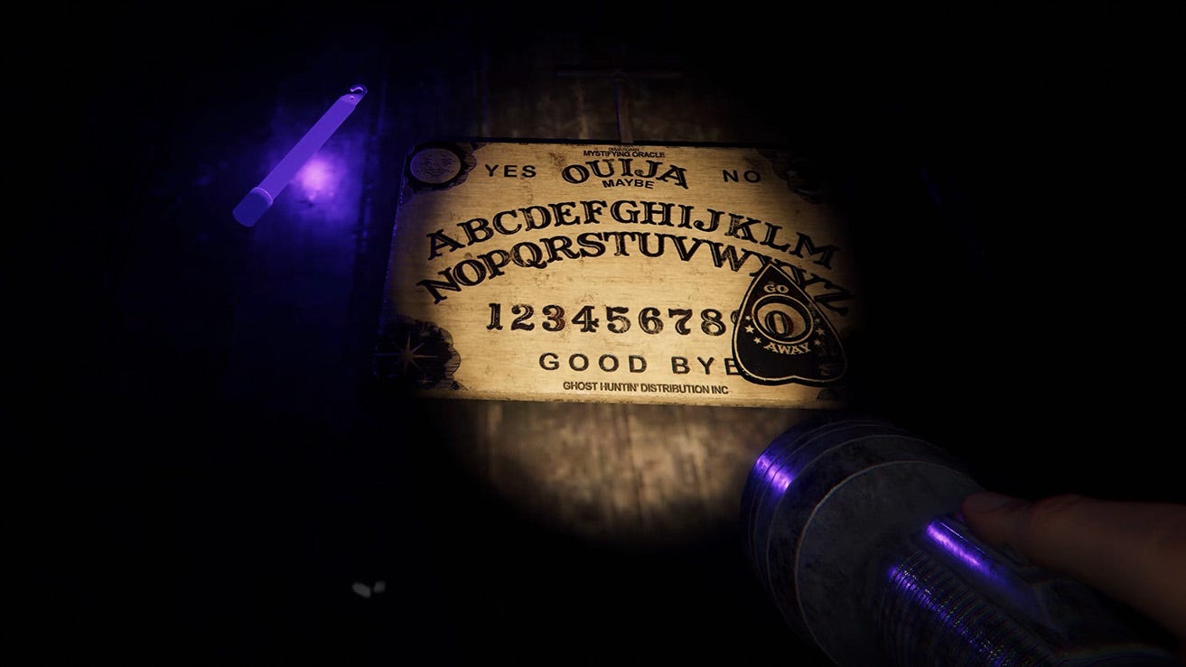 An Ouija board in the dark, lit by torchlight.