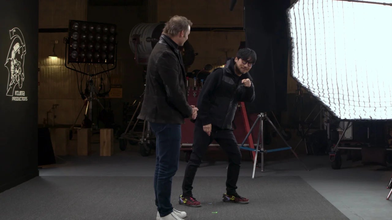 Kojima stands in a studio, dancing, to announce Physint. - 1