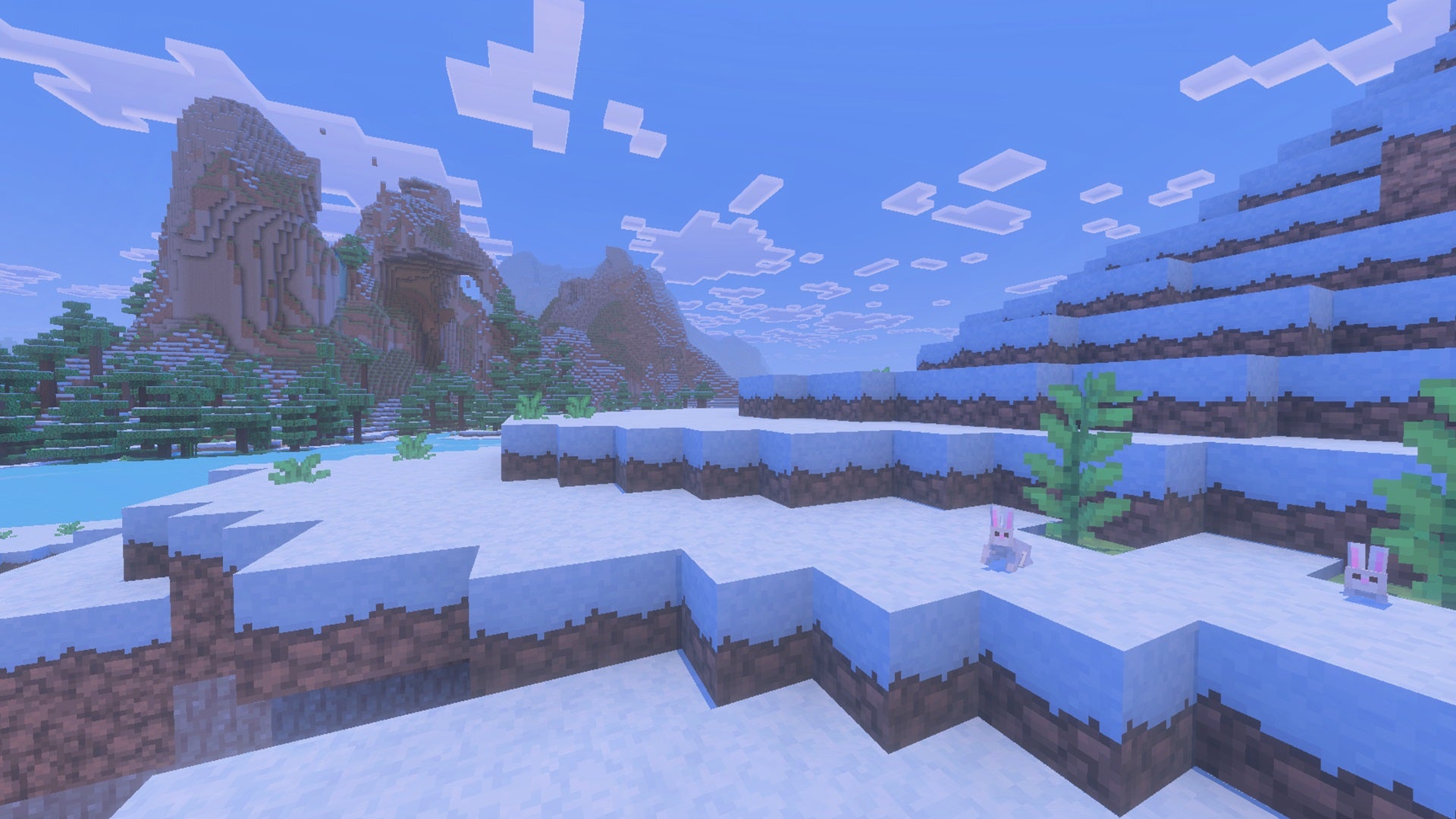 A snowy Minecraft Bedrock ridge overlooking a mountain. Snow rabbits and vegetation are nearby, - 14