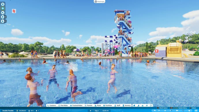 Bathers splash each other with water as a tall slide rises on the horizon.