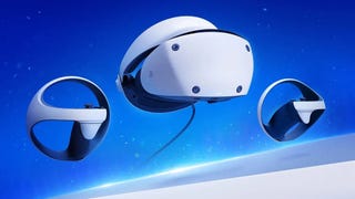 A PS VR2 headset with two controllers in front of a blue background.