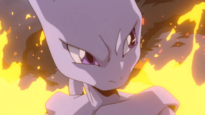 Mewtwo stood looking serious in front of a fire in Pokemon: The Movie.