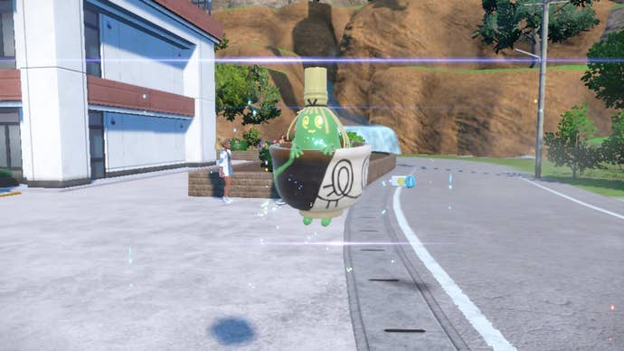 Pokemon Scarlet Violet evolve Poltchageist: A white and black teacup is floating above a street, with a formless green head sticking up from the cup