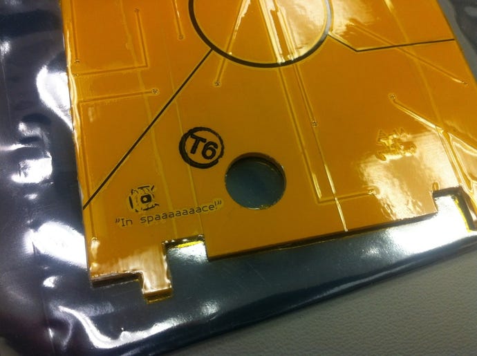 A photo showing a laser-etched image of a Portal 2 core on the side of an actual object sent into space.