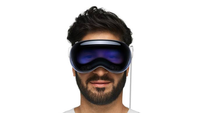 A dark haired man wearing the Apple Vision Pro headset