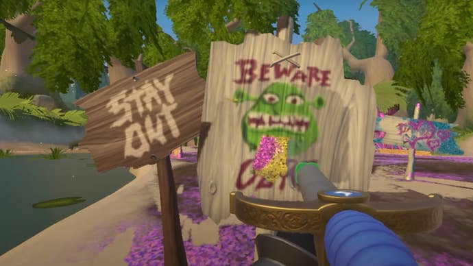 A screenshot from PowerWash Simulator’s paid Shrek DLC showing the player hosing down signs reading “Stay out” and “Beware ogre”.