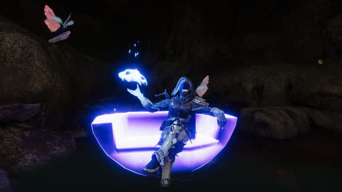 An in-game image of a Destiny 2 player character relaxing in a glowing neon chair.