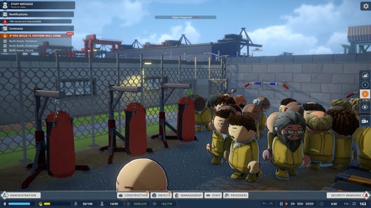 Prisoners crowd into the yard, where some punching bags hang unused.