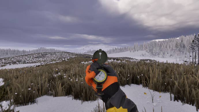 A hand is holding a compass in a first-person perspective, looking out at a mostly snow-covered hilly region in Project Artemis.