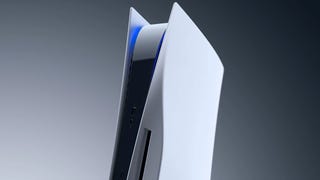 A side-on view of a vertical PS5 with the light bar glowing blue, on a grey background.