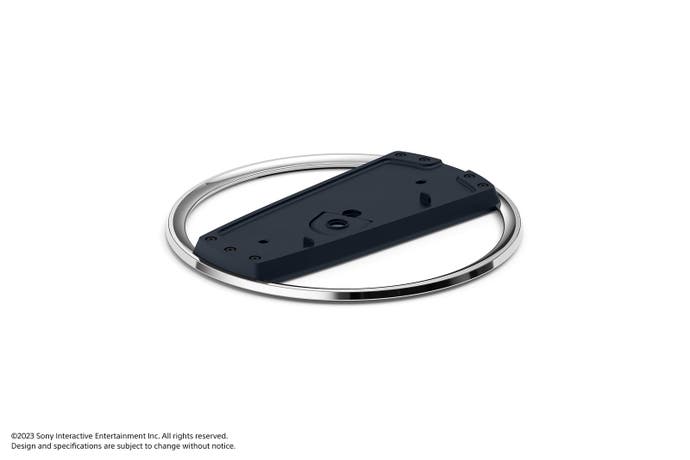 The optional vertical base being sold separately from the PS5 slim models. It consists of a metal ring with a plastic bit running through the middle, where the console sits.