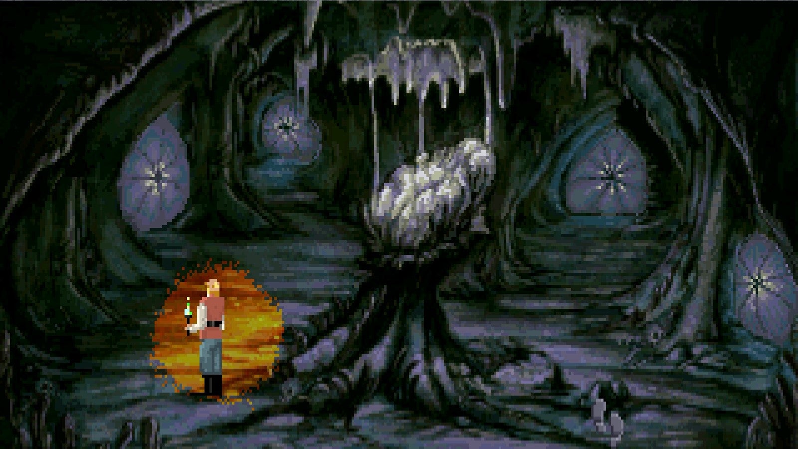 A man holds a torch in a twisty dark cave in Quest For Glory 4. - 3