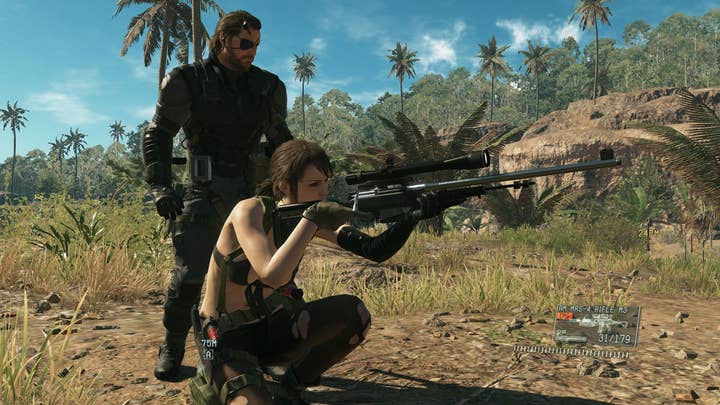 Metal Gear Solid 5's sniper Quiet crouches to take a shot as Venom Snake stands behind her