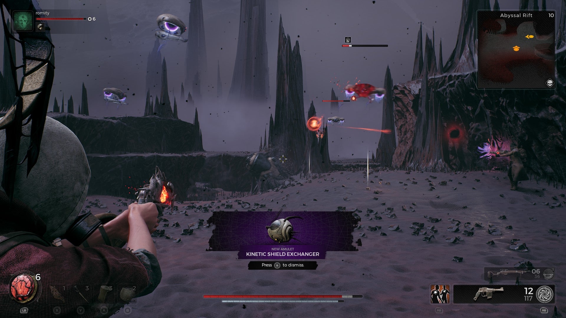 A gun aims at a flying machine in a grey, sterile world of Remnant 2. A pop-up for the new amulet &ldquo;Kinetic Shield Exchanger&rdquo; is on-screen.