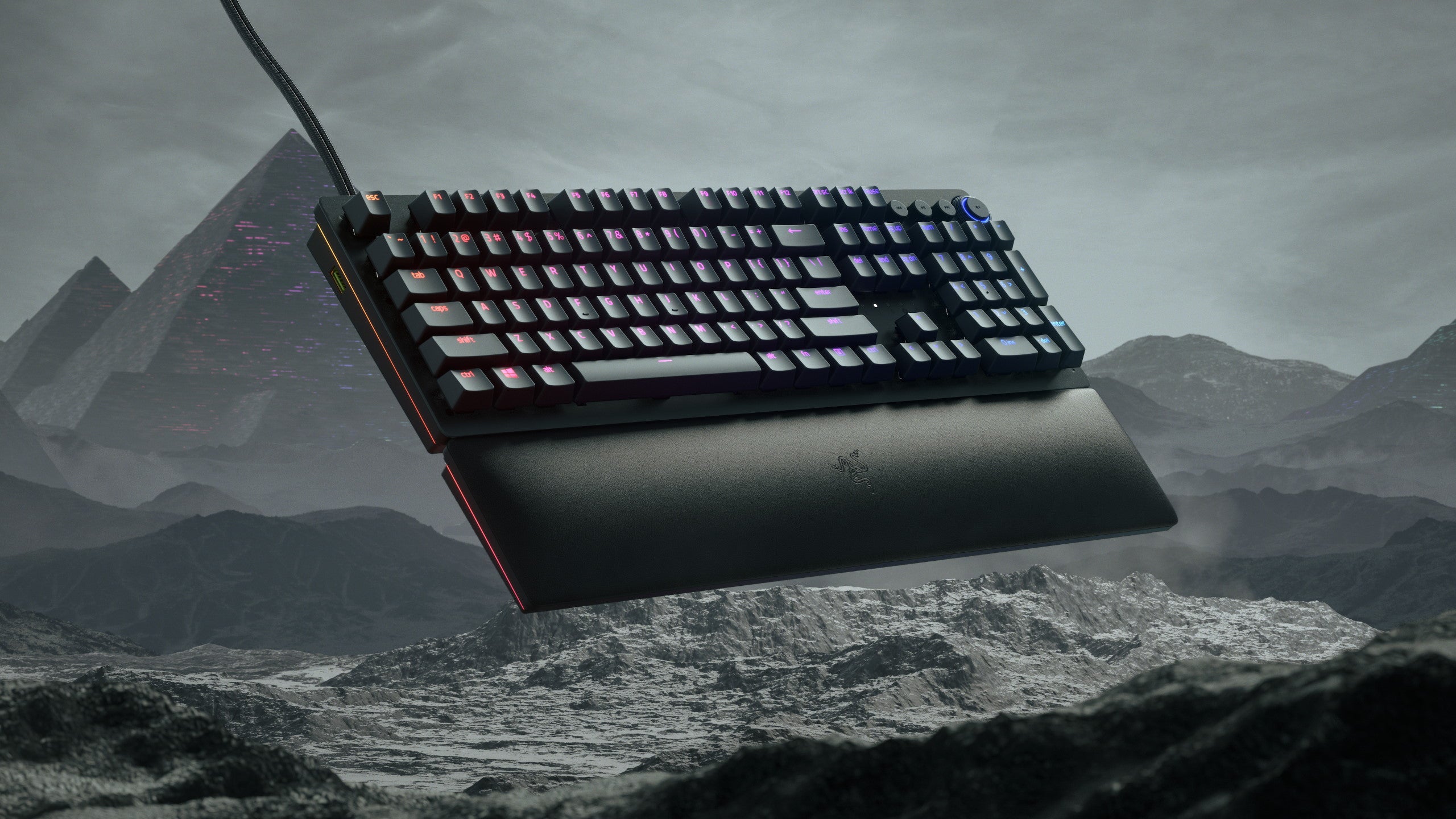 The Razer Huntsman V2 Analog keyboard in front of a rocky landscape
