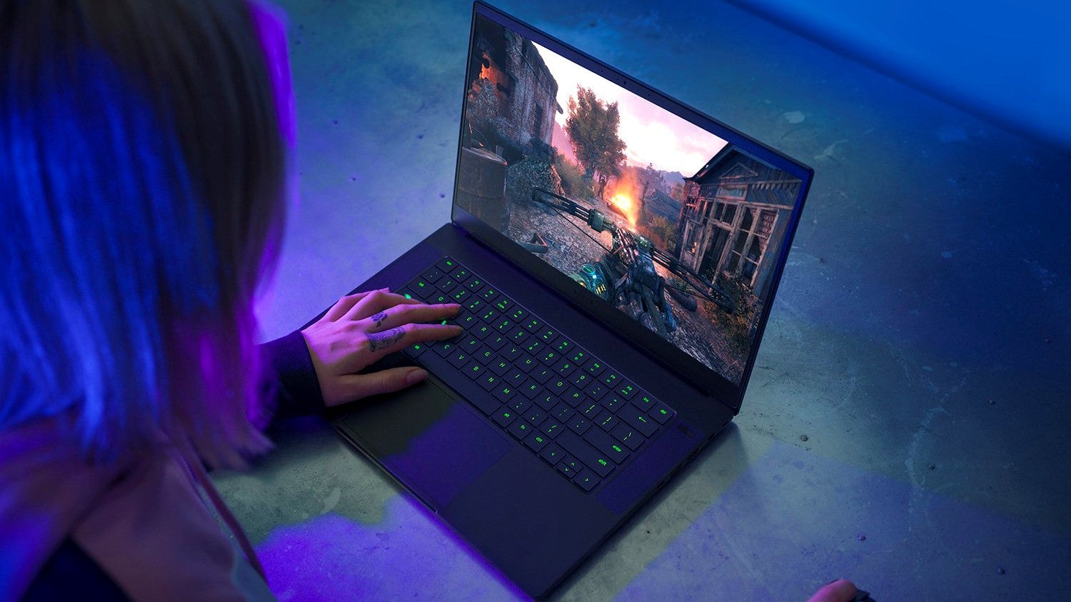 A woman plays Metro Exodus on a Razer Blade 15 Advanced gaming laptop.