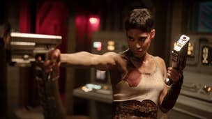 A woman with short hair and a bloody tank top is holding two sci-fi pistols in Rebel Moon Part 2.
