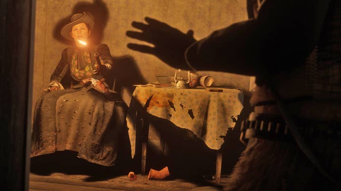 Legendary gunslinger Black Belle points a gun at an intruder in Red Dead Redemption 2.