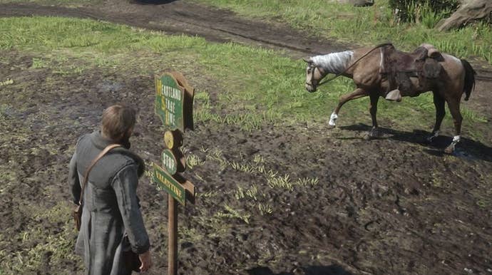 Arthur Morgan stood near a stagecoach stop in Red Dead Redemption 2.