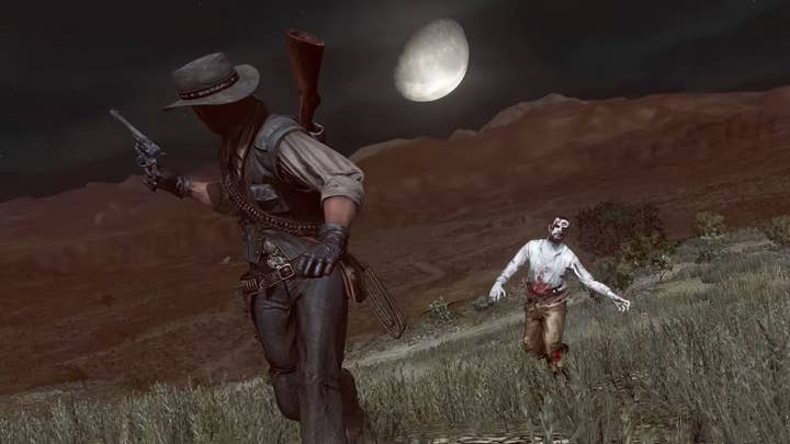 Red Dead Redemption: Zombie Nightmare screenshot showing the main character in a field at night with his gun drawn. Behind him, a pale white zombie with head and gut wounds shambles toward him