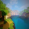 A screenshot of a river in Minecraft, with some trees on either side of the bank and a hill in the distance, taken using RedHat shaders.