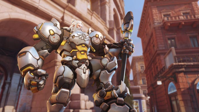 Overwatch 2’s Reinhardt standing proud with a leg on his hammer.