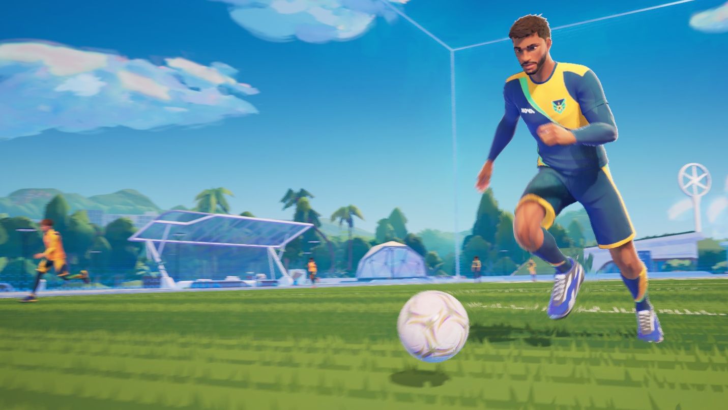 A footballer runs with the ball up a sunny pitch with a bright blue sky in the background. - 1