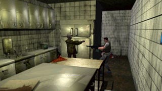 Chris Redfield points a shotgun at a zombie in a kitchen.
