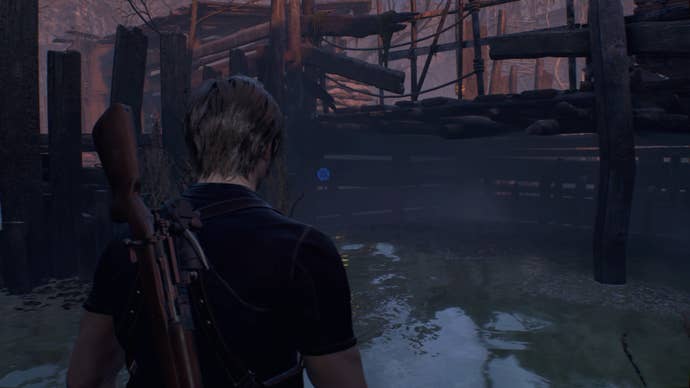 A blue medallion in the water of the Fish Farm in Resident Evil 4.